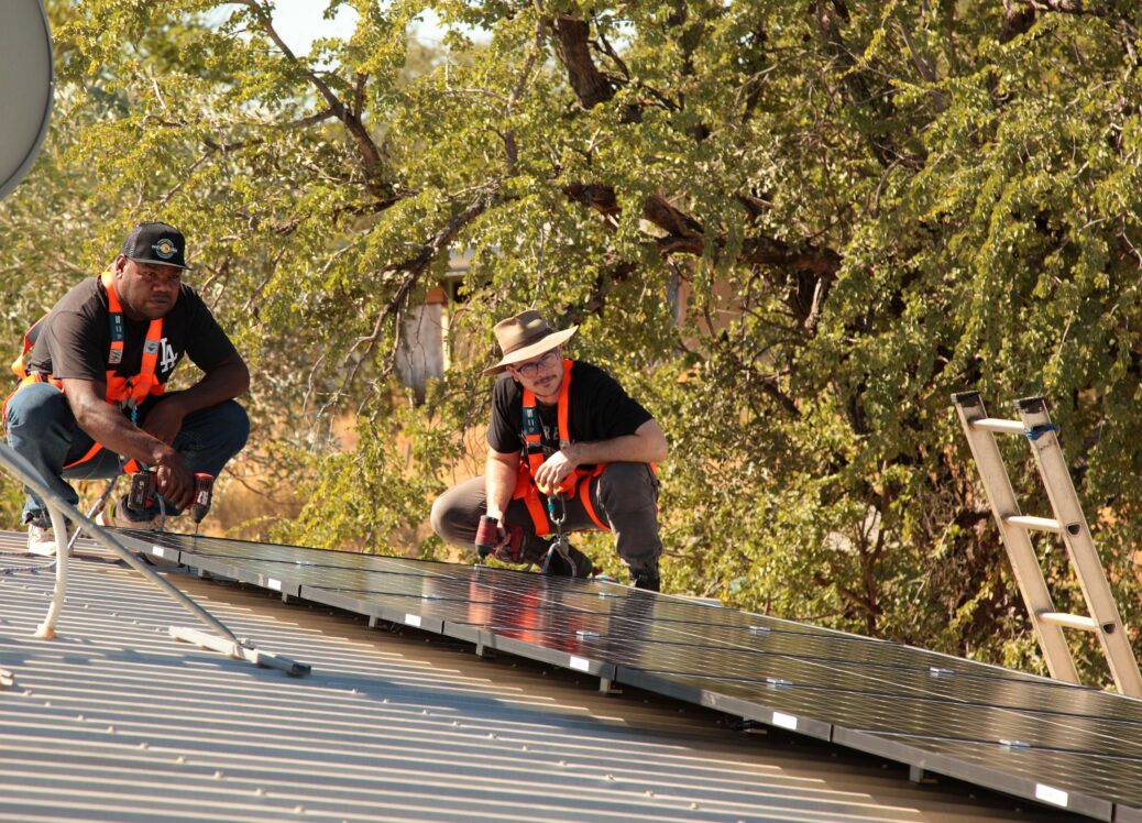 Terry Collins and Edi Donald installing solar on the Marlinja community centre, May 2021 First Nations Clean Energy Network